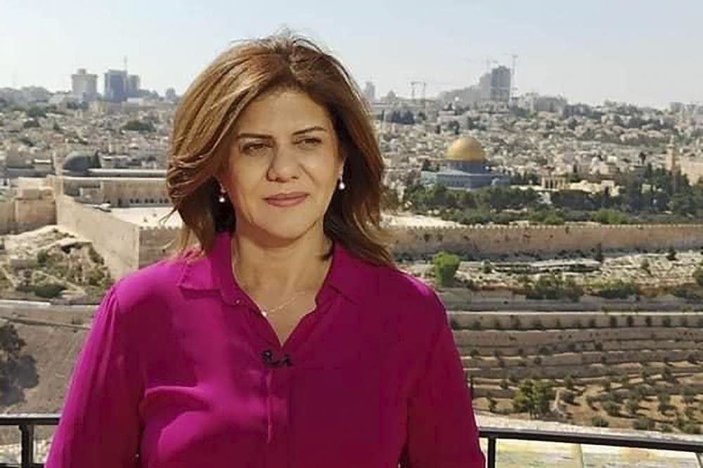 In this undated photo provided by Al Jazeera Media Network, Shireen Abu Akleh, a journalist for Al Jazeera network, stands in an area where the Dome of the Rock shrine at Al-Aqsa Mosque in the Old City of Jerusalem is seen at right in the background. Abu Akleh, a well-known Palestinian female reporter for the broadcaster's Arabic language channel, was shot and killed while covering an Israeli raid in the occupied West Bank town of Jenin early Wednesday, May 11, 2022. (Al Jazeera Media Network via AP)